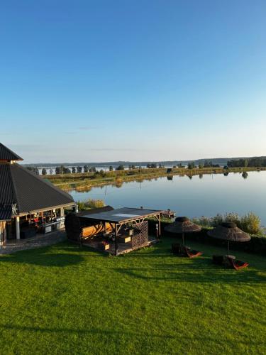 een uitzicht op een meer met een paviljoen en een gebouw bij Sterla - Masuria in Giżycko