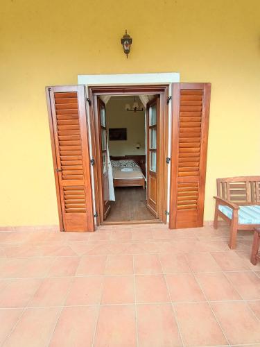 an open door to a bedroom with a bed at Sasréti Vadászkastély Almamellék in Almamellék