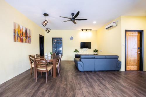 a living room with a blue couch and a table at R S Home in Tawau