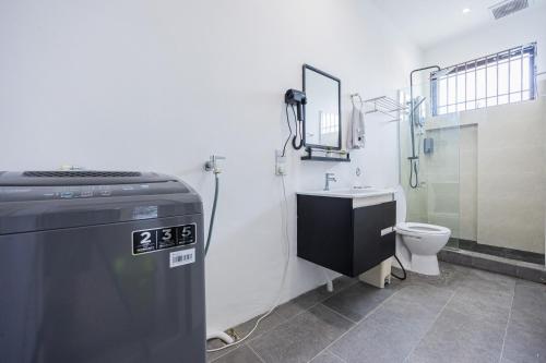 a bathroom with a shower and a toilet in it at R S Home in Tawau