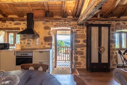 a kitchen with a table and a door to a balcony at Bilbao Nature with parking by Aston Rentals in Erandio