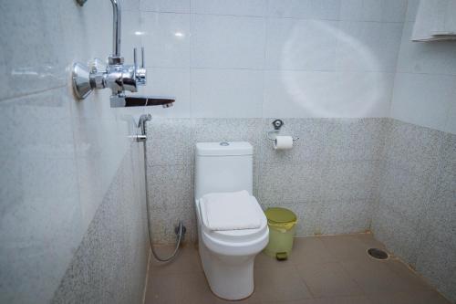 a small bathroom with a toilet and a shower at Hotel Fewa Camp in Pokhara
