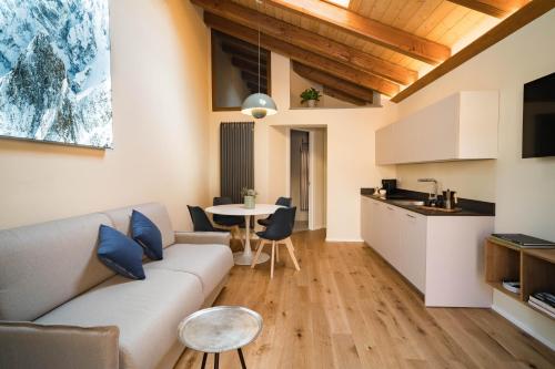 a living room with a couch and a table at Aosta Holiday Apartments - Sant'Anselmo in Aosta