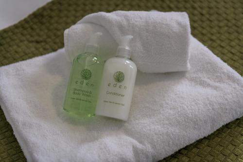 a bottle of soap sitting on top of a towel at Wood House by EDEN Accommodation - 3 Bedroom Whole House, Sleeps 6 in Kettering