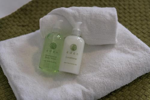 a bottle of soap sitting on top of a towel at Wood House - 5 Beds, Suitable for contractors in Kettering