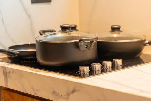 two pots sitting on top of a stove at Namu Garden Hotel & Spa - Adults Only in Puerto Viejo