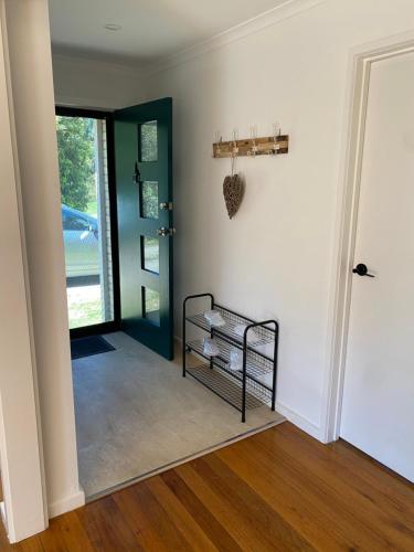 a room with a hallway with a door and a shelf at The Delightful Tee House - Kilmore in Kilmore