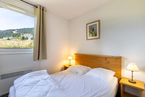 Postel nebo postele na pokoji v ubytování A l'Orée des Cimes
