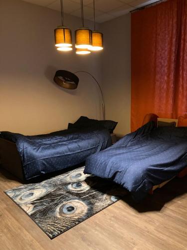 a bedroom with two beds and a rug on the floor at Pumpura apartamenti ***** in Talsi