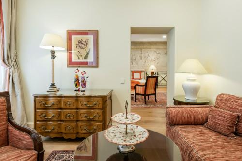 a living room with a couch and a table at Stikliai Hotel - Relais & Châteaux in Vilnius