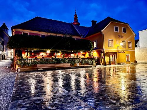 a building on a rainy street in a city at MuziKafe - Home of Culture in Ptuj