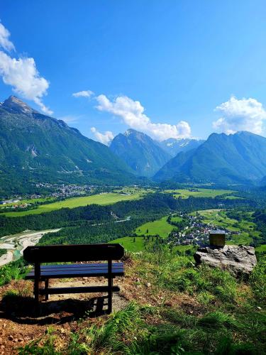 a bench sitting on a hill overlooking a valley at Apartma Kati in Bovec