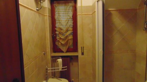 a bathroom with a shower and a toilet and a mirror at LA CASA DEI RICORDI in Lanna