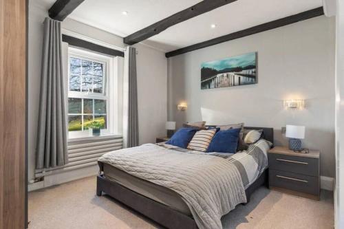 a bedroom with a large bed and a window at The Annex in Saundersfoot