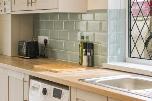 a kitchen with a sink and a counter top at Modern home near Alexandra Dock in Great Coates