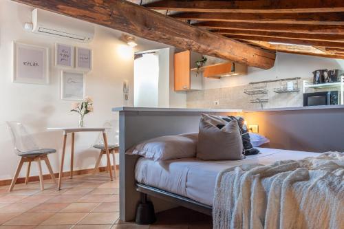 a bedroom with a bed and a table in a room at Colours Studio 10 m away Piazza del Campo in Siena