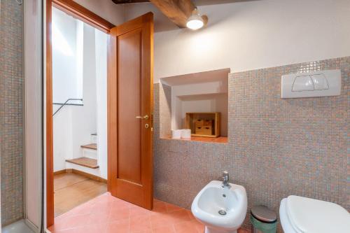 a bathroom with a sink and a toilet and a mirror at Colours Studio 10 m away Piazza del Campo in Siena