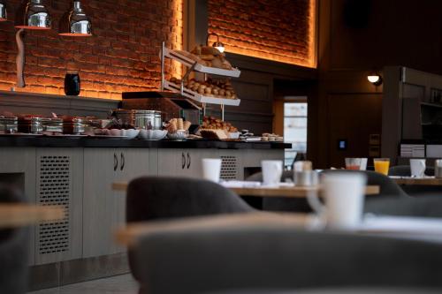 a restaurant with a counter with food on it at Port Bosphorus Hotel in Istanbul