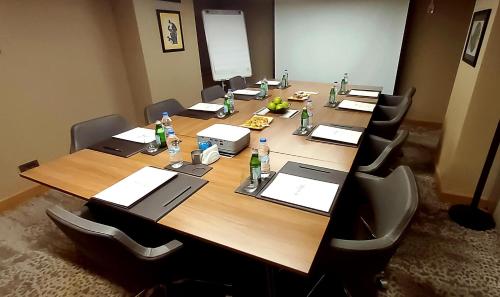 a conference room with a long wooden table with bottles on it at Port Bosphorus Hotel in Istanbul