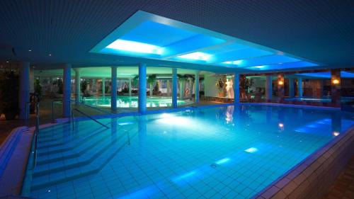 an indoor swimming pool at night with blue lights at Ruissalo Spa Hotel in Turku