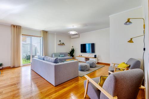 a living room with two couches and a tv at Lisbon Stunning House with Terrace in Lisbon