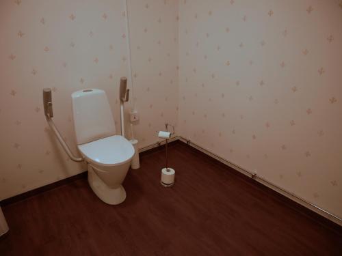 a bathroom with a toilet and a phone at Jädra Gårdshotel in Enköping