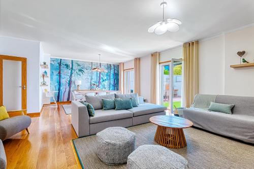a living room with two couches and a table at Lisbon Stunning House with Terrace in Lisbon