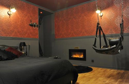 a bedroom with a bed and a fire place at L'Un Des Sens in Châtel-Guyon