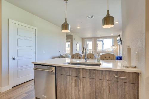 a kitchen with a sink and a counter at Castle Rock Condo - Walk to Dining and Shopping! in Castle Rock