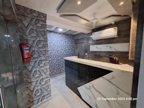 a kitchen with a fire extinguisher on the wall at HOTEL KINGDOM in Gandhinagar