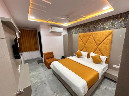 een hotelkamer met een bed en een stoel bij HOTEL KINGDOM in Gandhinagar