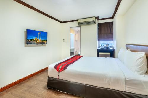 a bedroom with a large bed in a room at Nasa Bangkok in Bangkok