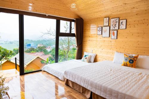 a bedroom with a bed and a large window at Avatar Homestay & Coffee - Mộc Châu in Mộc Châu