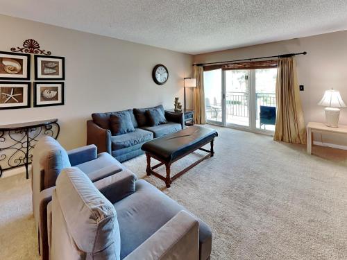 a living room with a couch and a table at Emerald Isle Fort Walton Beach #209 in Fort Walton Beach