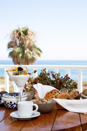 a table with a plate of food and cups of coffee at KAMEO, Antiparos in Andiparos