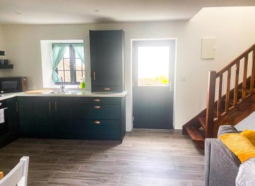 a kitchen with a sink and a counter top at Shannon Castle Holiday Cottages - Type D by Trident Holiday Homes in Ballysteen