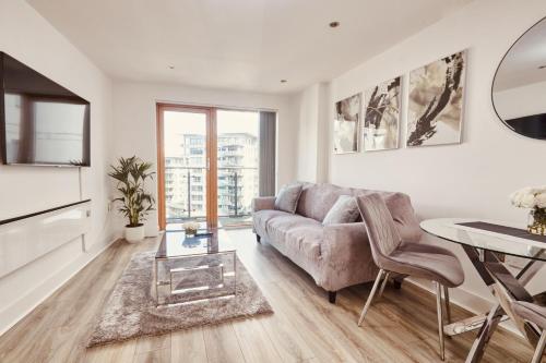 a living room with a couch and a table at Deluxe River Canal View & Free Secure Parking! in Leeds