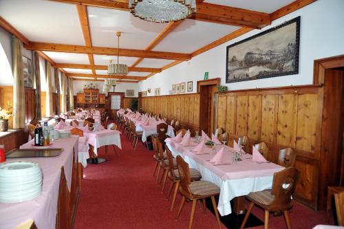 a dining room with tables and chairs with pink tablecloths at Hotel Passo Stelvio in Passo Stelvio