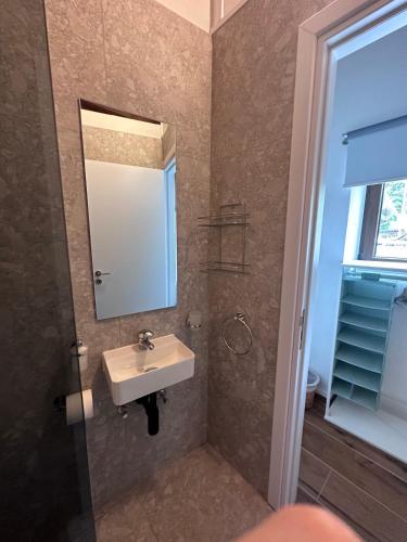 a bathroom with a sink and a mirror at Kallithea INN in Platres