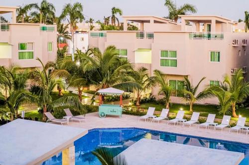 a view of a resort with a pool and palm trees at Playa Palmera Beach Resort in Punta Cana