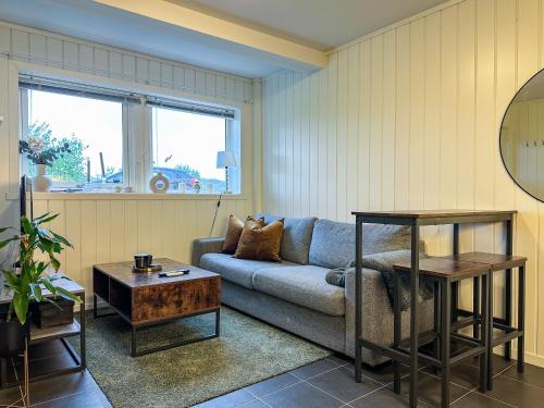 a living room with a couch and a table at Panorama View - FREE Parking - PERFECT For Couples in Tromsø