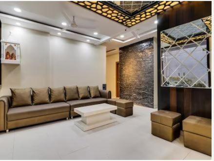 a living room with a couch and a table at HOTEL HARIHAR in Haridwār