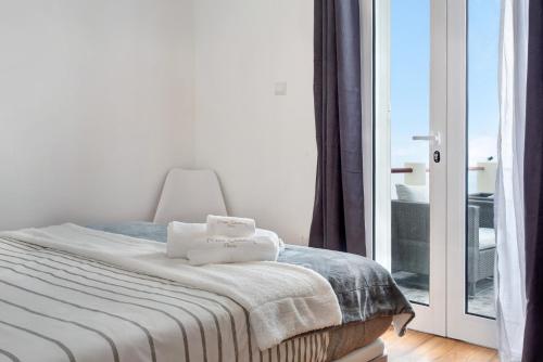 a bedroom with a bed and a sliding glass door at Simão House in Calheta