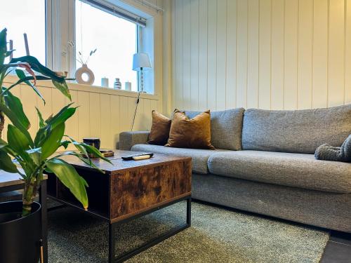 a living room with a couch and a coffee table at Beautiful City View PERFECT For Couples in Tromsø