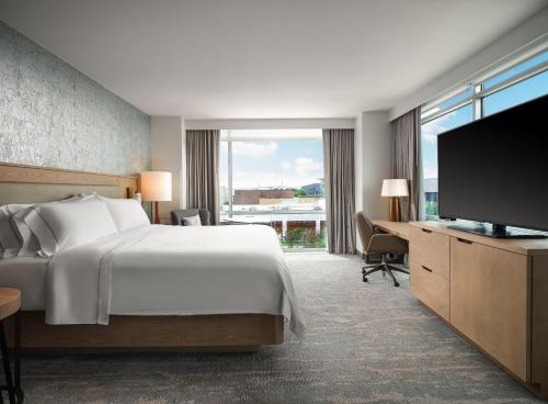 a hotel room with a bed and a television at The Westin Austin at The Domain in Austin