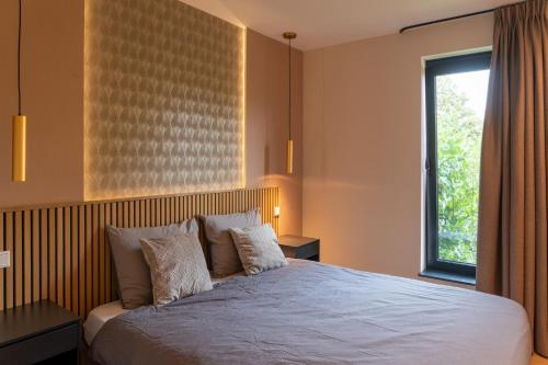a bedroom with a large bed and a window at De Witte Bergvliet in Oosterhout