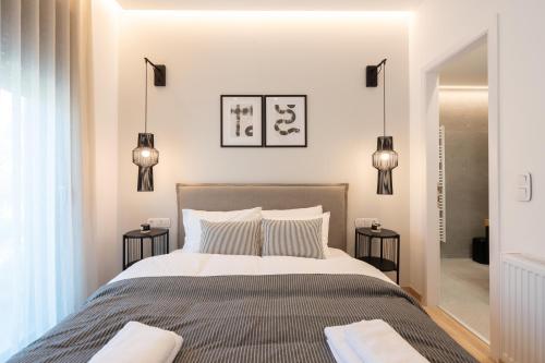 a bedroom with a large bed with two tables at The Edge - Luxury Residences in Athens