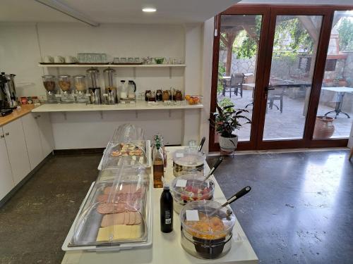 a kitchen with a table with food on it at Hotel Astron in Mirina