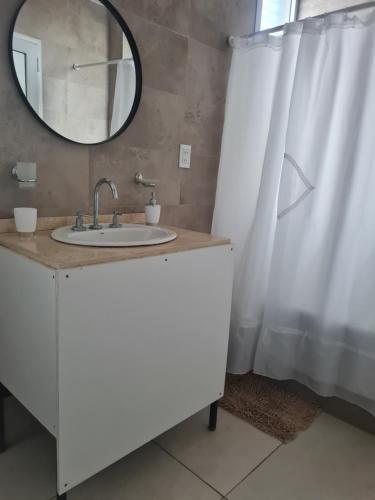 a bathroom with a sink and a mirror at Casa "Wasi" Carrodilla-Lujan de Cuyo in Ciudad Lujan de Cuyo