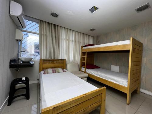 מיטה או מיטות קומותיים בחדר ב-Hospedagem BRASILIANAS
